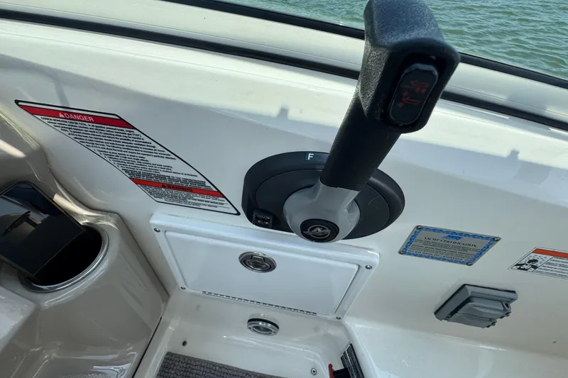 Slide: The Image of Throttle control of 2006 Sea Ray 260 Sundancer boat, with warning labels and certification. - 18