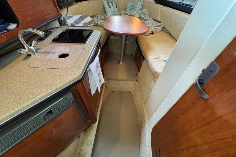 Slide: The Image of Interior of 2006 Sea Ray 260 Sundancer with kitchenette and seating area. - 27