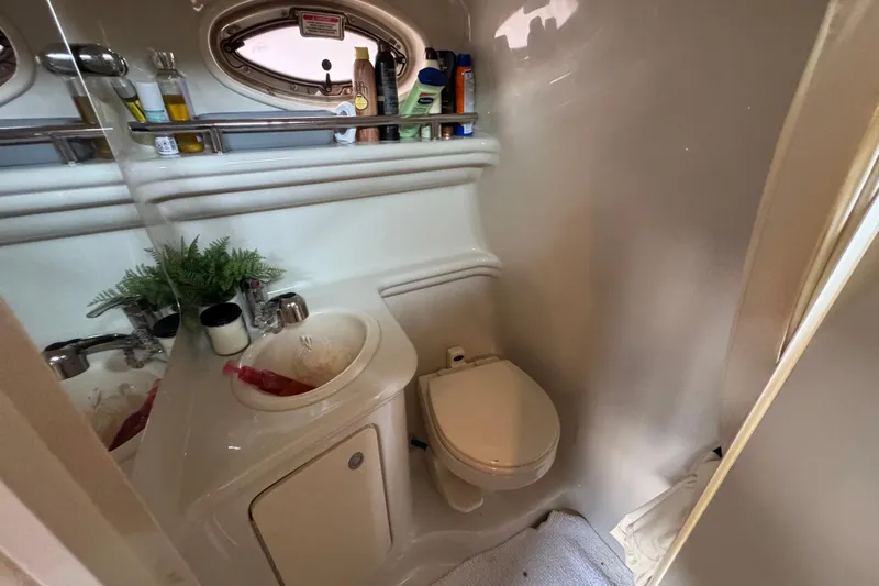 Slide: The Image of Compact bathroom in 2006 Sea Ray 260 Sundancer boat with sink, toilet, and toiletries. - 28