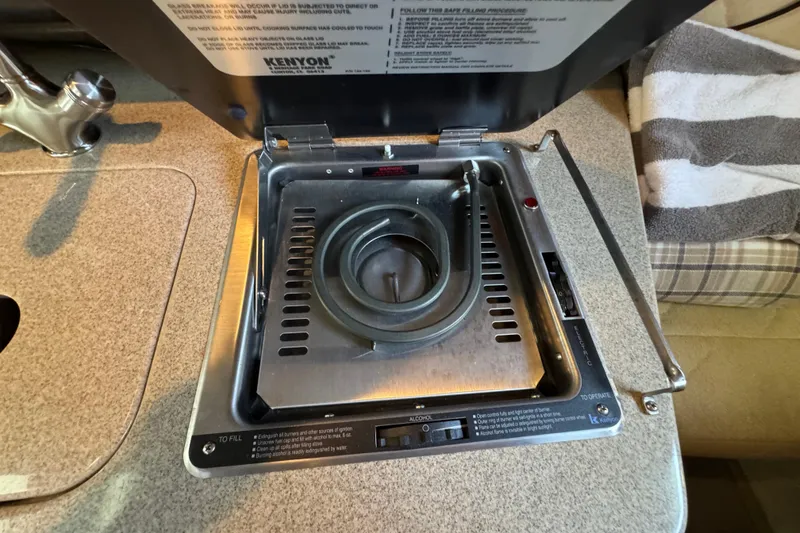 Slide: The Image of Stove on 2006 Sea Ray 260 Sundancer boat, featuring a compact Kenyon cooktop. - 30