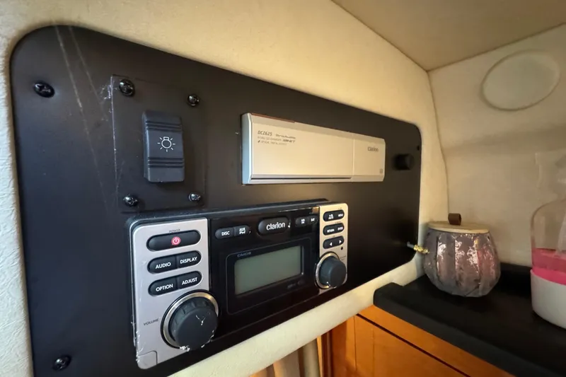 Slide: The Image of Control panel inside 2006 Sea Ray 260 Sundancer boat, featuring Clarion audio system. - 32