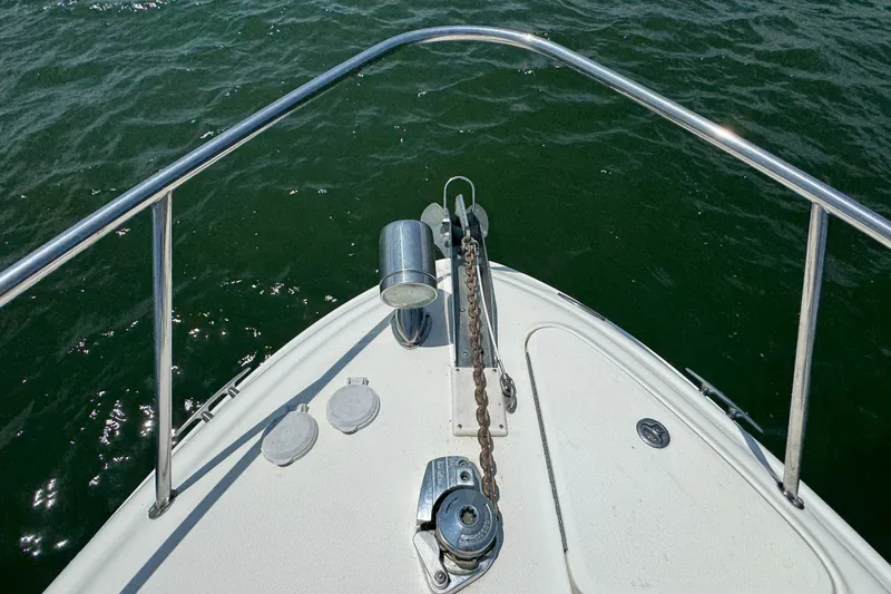 Slide: The Image of Bow of 2006 Sea Ray 260 Sundancer on water, featuring anchor and railing. - 36