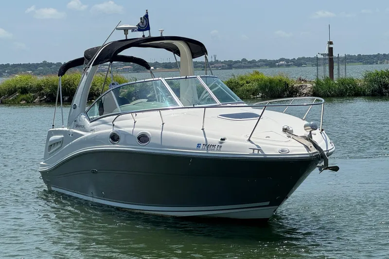 Slide: The Image of 2006 Sea Ray 260 Sundancer boat on calm water, sunny day, scenic background. - 4