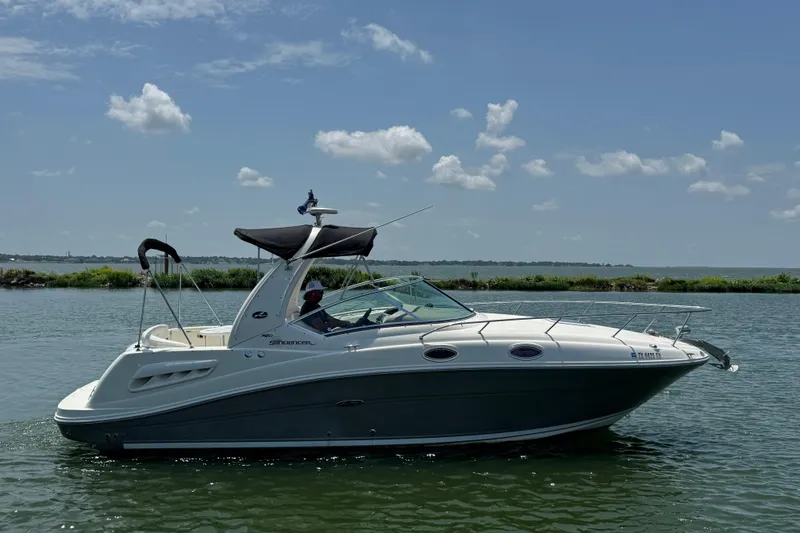 Slide: The Image of 2006 Sea Ray 260 Sundancer boat cruising on a sunny day with clear skies. - 5
