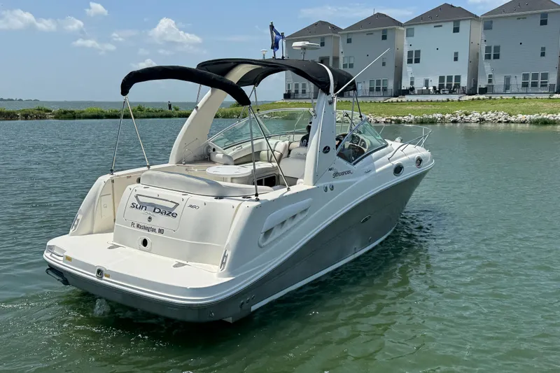 Slide: The Image of 2006 Sea Ray 260 Sundancer boat on water near waterfront homes. - 6