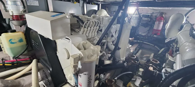 Slide: The Image of Engine room of a 2003 Sea Ray 390 Motor Yacht, featuring mechanical components and fire extinguisher. - 14