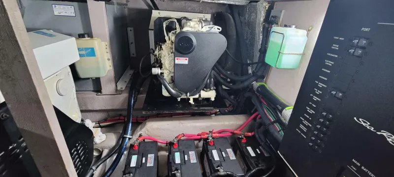 Slide: The Image of Engine room of a 2003 Sea Ray 390 Motor Yacht with visible batteries and control panel. - 15