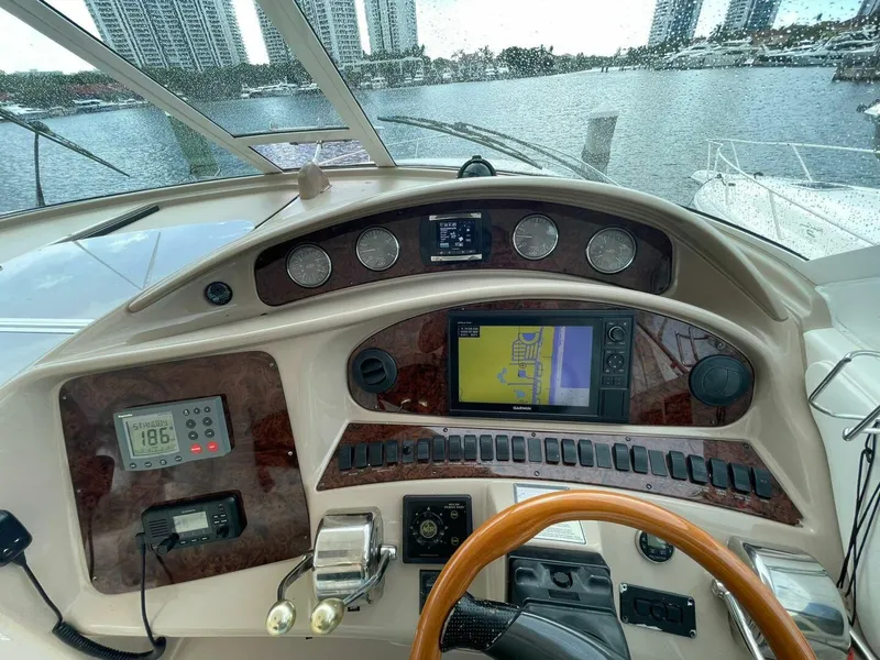 Slide: The Image of 2003 Sea Ray 390 Motor Yacht helm with navigation equipment and cityscape view. - 2