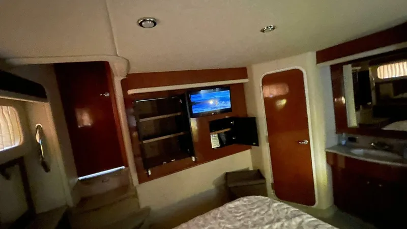 Slide: The Image of Interior of 2003 Sea Ray 390 Motor Yacht with TV, cabinets, and wood finishes. - 6