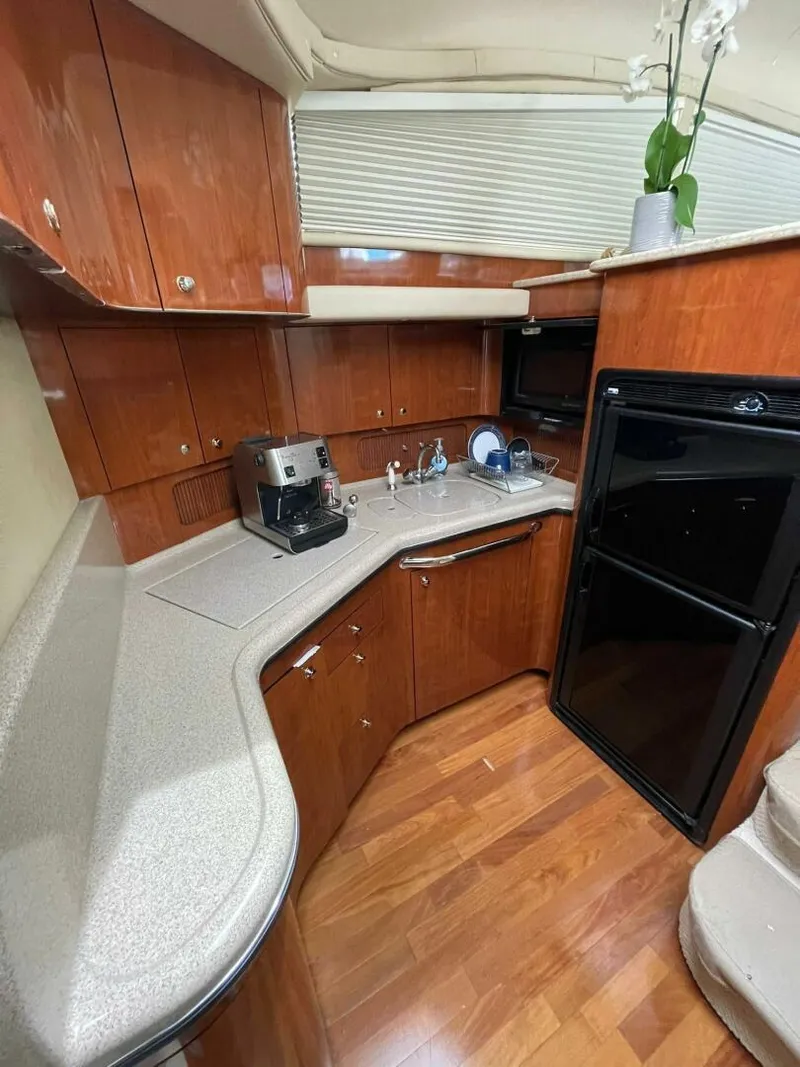 Slide: The Image of Luxurious 2003 Sea Ray 390 Motor Yacht kitchen with wood cabinetry and modern appliances. - 7