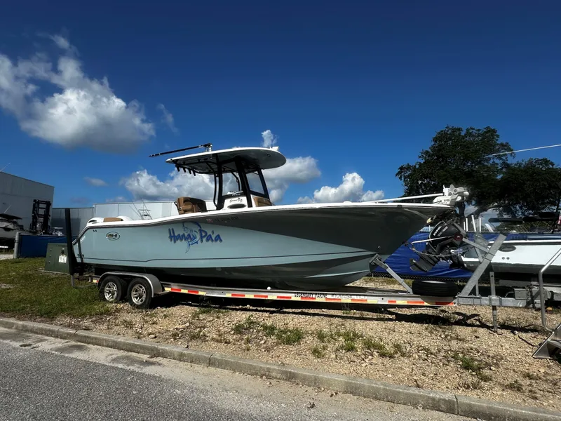 The Image of 2020 Sea Hunt Gamefish 27 Coffin Box boat on trailer under blue sky. - 1