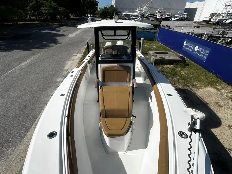 Slide: The Image of 2020 Sea Hunt Gamefish 27 Coffin Box boat with tan seating, docked outdoors. - 10