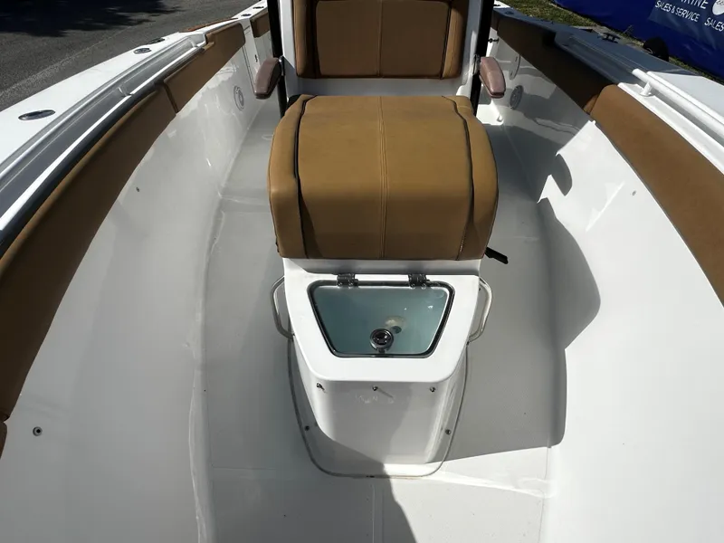 Slide: The Image of 2020 Sea Hunt Gamefish 27 Coffin Box interior with tan seating and storage. - 11