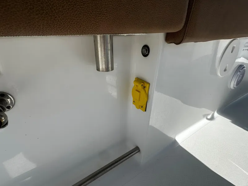 Slide: The Image of Interior detail of 2020 Sea Hunt Gamefish 27 Coffin Box, featuring yellow outlet and brown upholstery. - 14