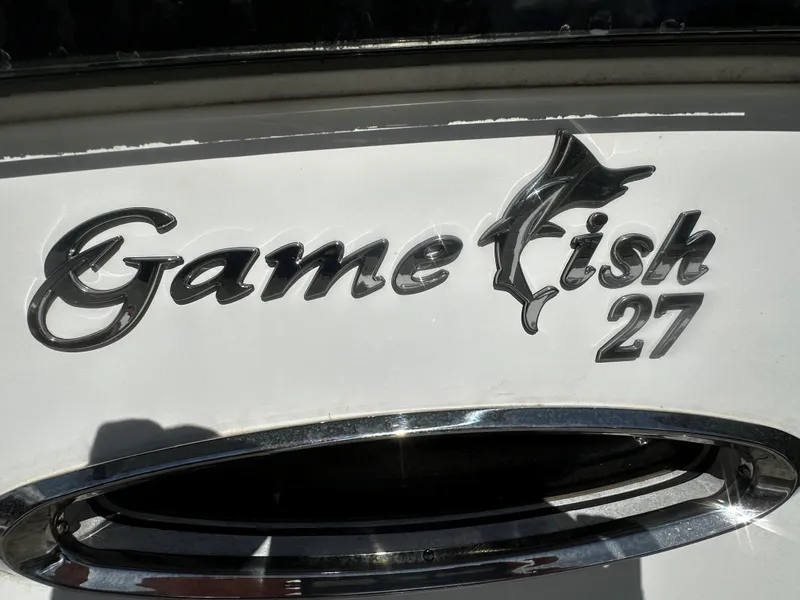Slide: The Image of Sea Hunt Gamefish 27 logo on 2020 model boat, featuring sleek chrome lettering. - 15