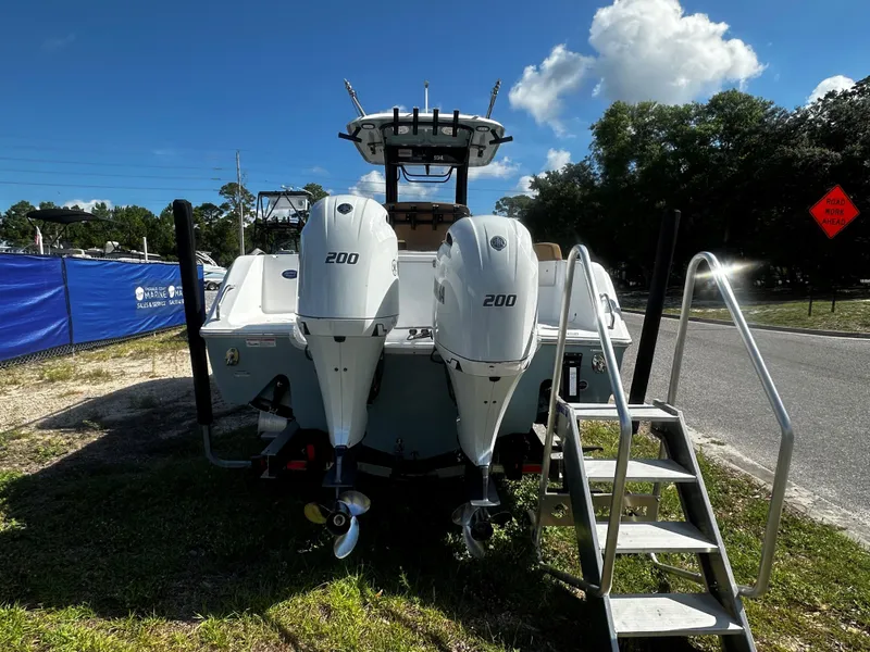 Slide: The Image of 2020 Sea Hunt Gamefish 27 Coffin Box boat with twin Yamaha 200 engines, parked outdoors. - 3