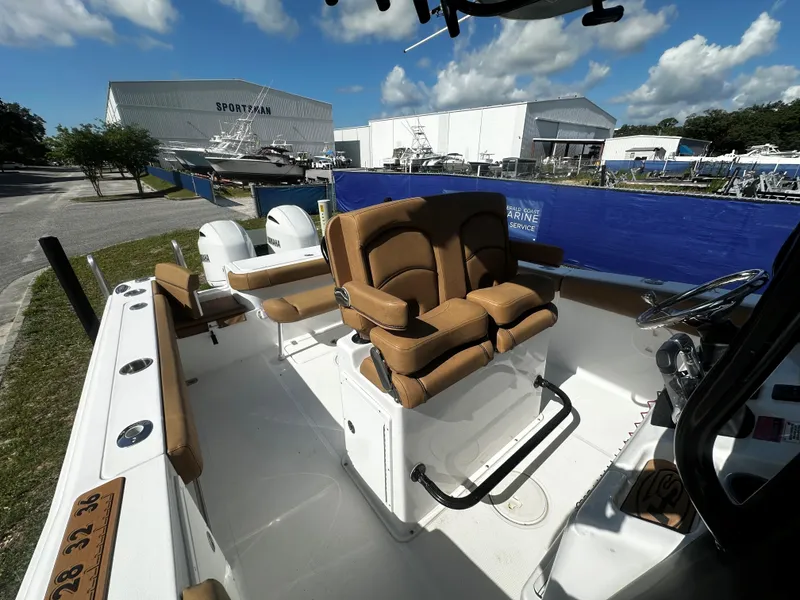 Slide: The Image of 2020 Sea Hunt Gamefish 27 Coffin Box boat interior with dual seats and steering wheel. - 8