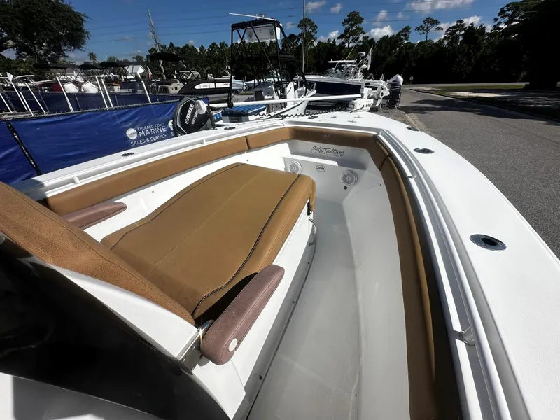 Slide: The Image of 2020 Sea Hunt Gamefish 27 Coffin Box boat interior with tan seating and white deck. - 9