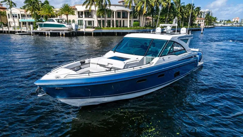 Slide: The Image of 2019 Formula 430 All Sport Crossover boat on water, near luxury waterfront homes. - 19