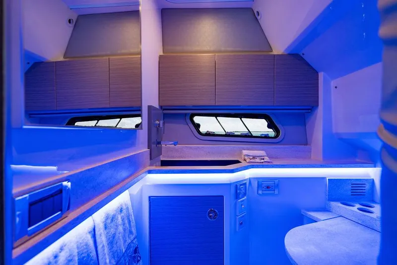 Slide: The Image of Interior of 2019 Formula 430 All Sport Crossover with modern blue lighting and sleek cabinetry. - 43