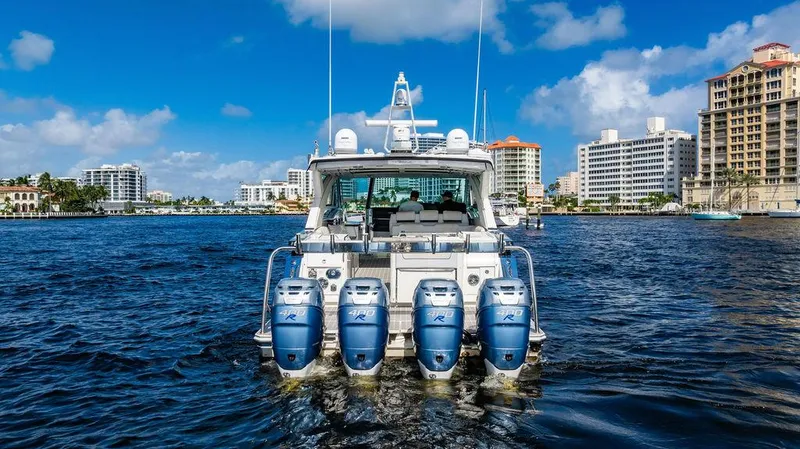 Slide: The Image of 2019 Formula 430 All Sport Crossover boat with four engines on a sunny waterfront. - 5