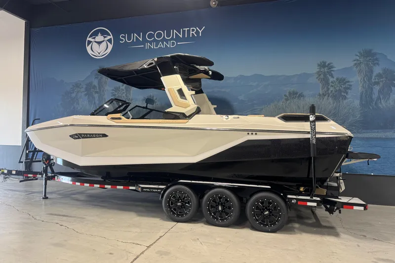Slide: The Image of 2026 Nautique Super Air Nautique G25 Paragon boat on trailer at Sun Country Inland showroom. - 1