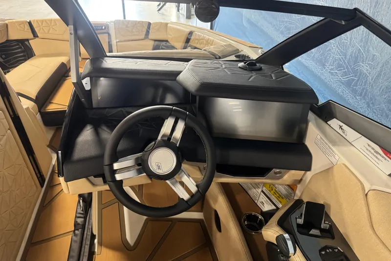 Slide: The Image of 2026 Nautique Super Air Nautique G25 Paragon cockpit with modern steering and luxurious seating. - 11