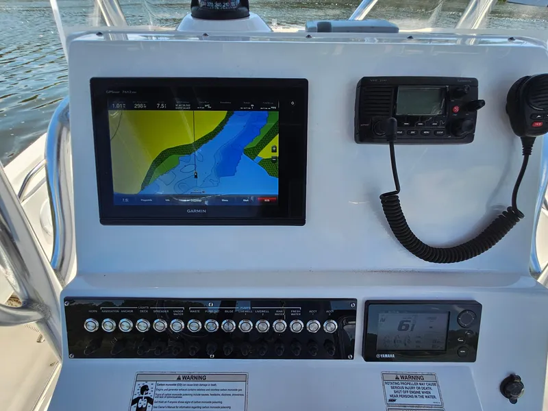 Slide: The Image of Edgewater 228CC 2016 boat dashboard with Garmin navigation and communication equipment. - 13