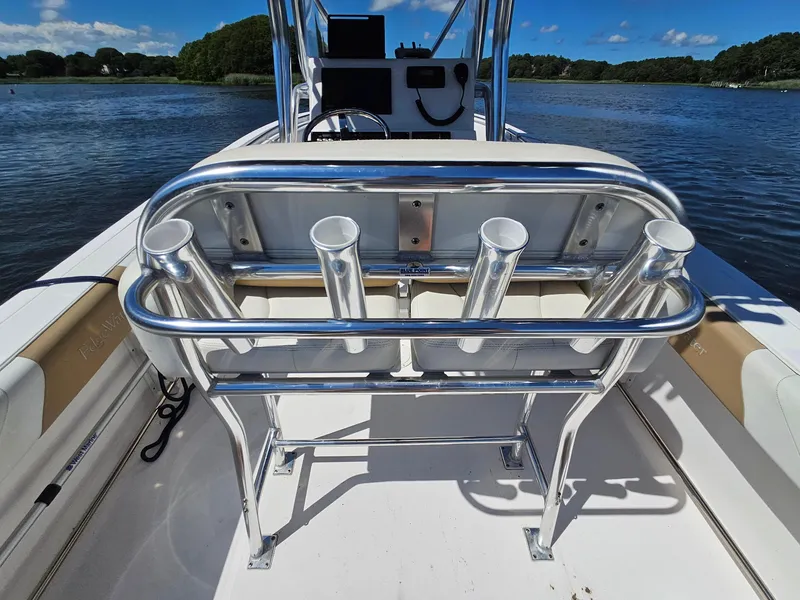 Slide: The Image of 2016 Edgewater 228CC boat with rod holders on a sunny day by the water. - 17