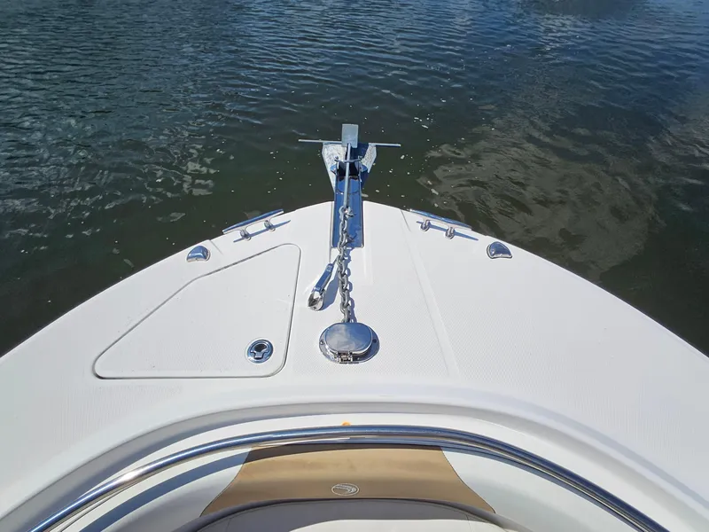 Slide: The Image of Bow of 2016 Edgewater 228CC boat with anchor, on calm water. - 5