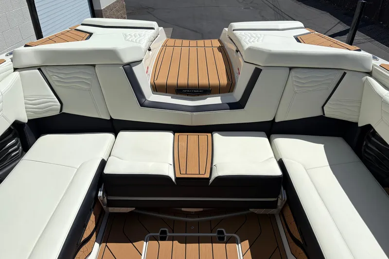 Slide: The Image of 2026 Nautique Super Air Nautique G25 interior with luxurious seating and teak flooring. - 10