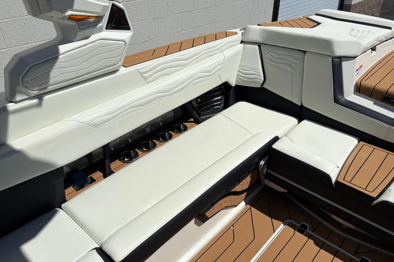 Slide: The Image of 2026 Nautique Super Air Nautique G25 interior with white leather seating and cup holders. - 11