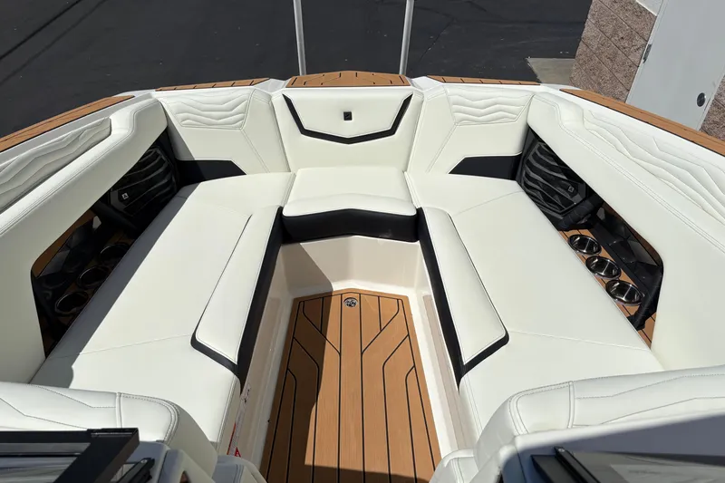 Slide: The Image of 2026 Nautique Super Air Nautique G25 interior with white seating and wood accents. - 17
