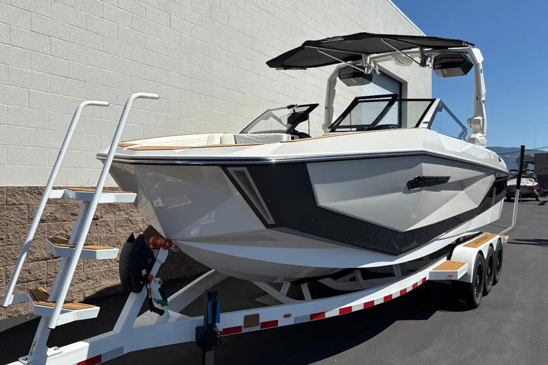 Slide: The Image of 2026 Nautique Super Air Nautique G25 boat on trailer, parked outdoors. - 6