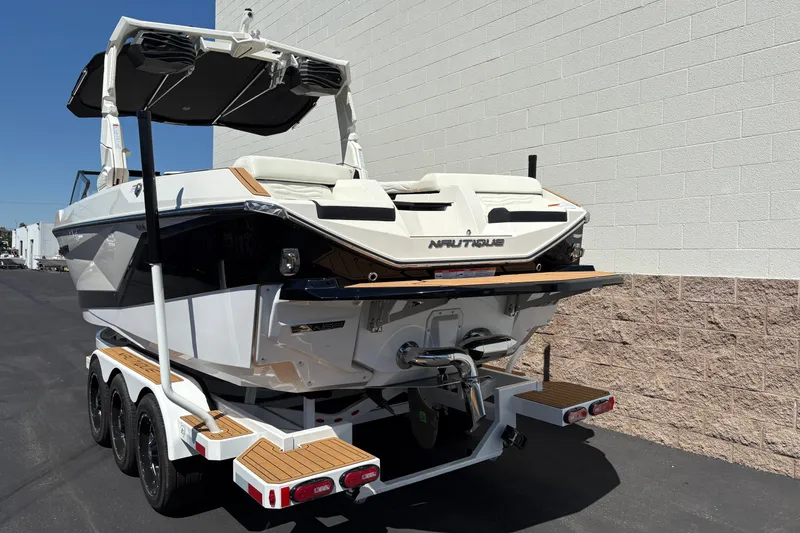 Slide: The Image of 2026 Nautique Super Air Nautique G25 boat on trailer, rear view. - 7