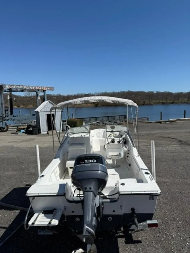 Slide: The Image of 2001 Edgewater 185DC boat at Beacon Point Marine, parked near a scenic waterfront. - 5