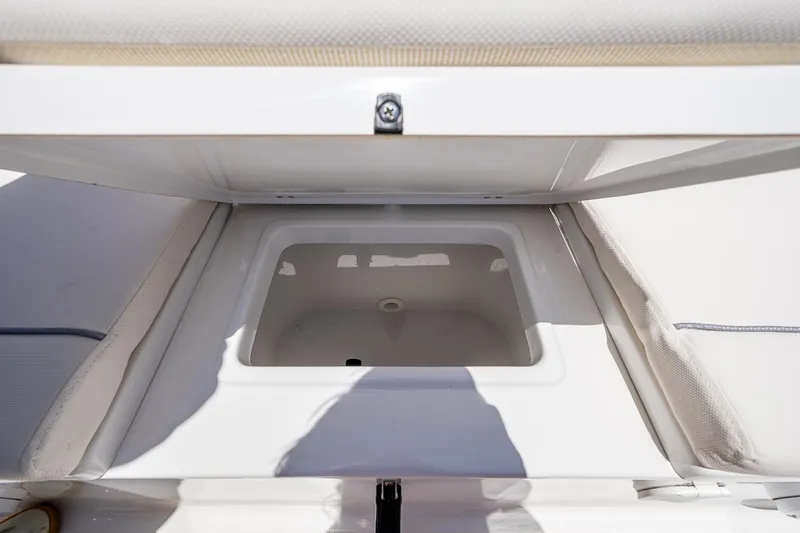 Slide: The Image of Open storage compartment on 2024 Sea Hunt Ultra 239 SE boat. - 15