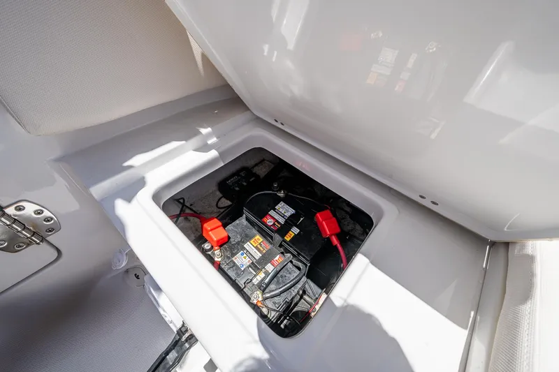 Slide: The Image of Battery compartment of 2024 Sea Hunt Ultra 239 SE boat, showcasing wiring and connections. - 16