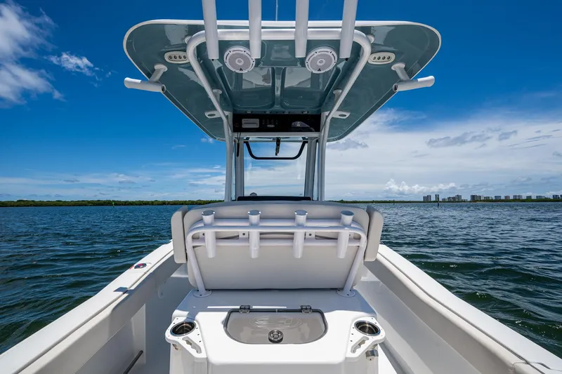Slide: The Image of 2024 Sea Hunt Ultra 239 SE boat on water, clear sky, modern design. - 19