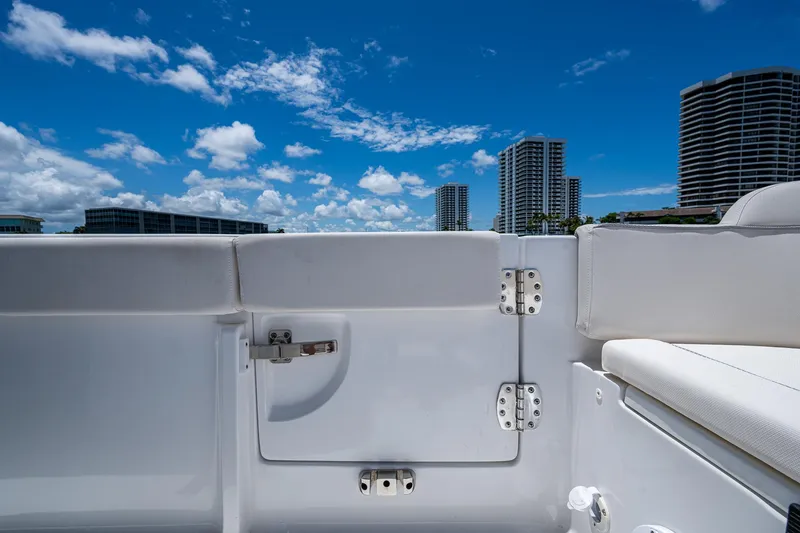 Slide: The Image of 2024 Sea Hunt Ultra 239 SE boat interior with city skyline and blue sky. - 21