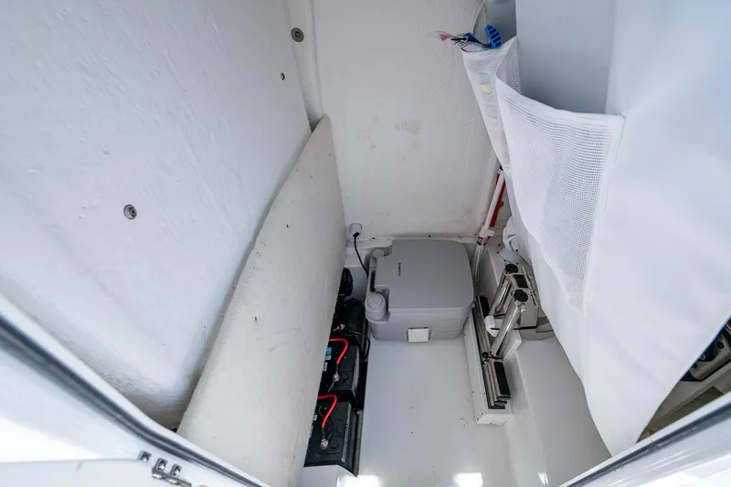 Slide: The Image of Interior of 2024 Sea Hunt Ultra 239 SE boat, featuring storage and equipment space. - 25