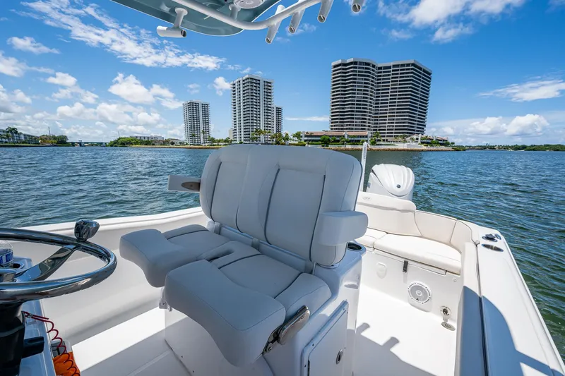 Slide: The Image of 2024 Sea Hunt Ultra 239 SE boat interior with city skyline in background. - 30