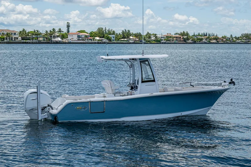 Slide: The Image of 2024 Sea Hunt Ultra 239 SE boat on calm water, showcasing sleek design and modern features. - 31