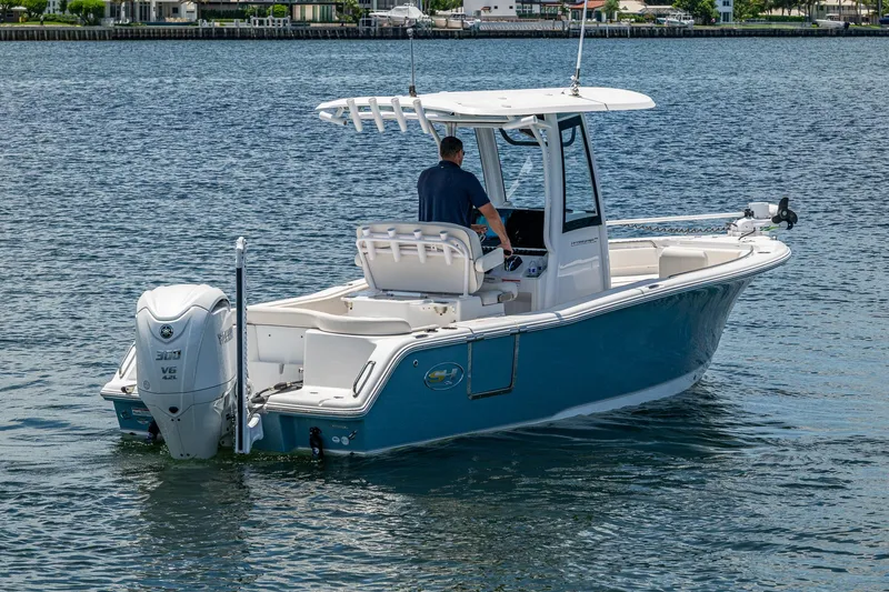 Slide: The Image of 2024 Sea Hunt Ultra 239 SE boat on water, featuring sleek design and powerful engine. - 32