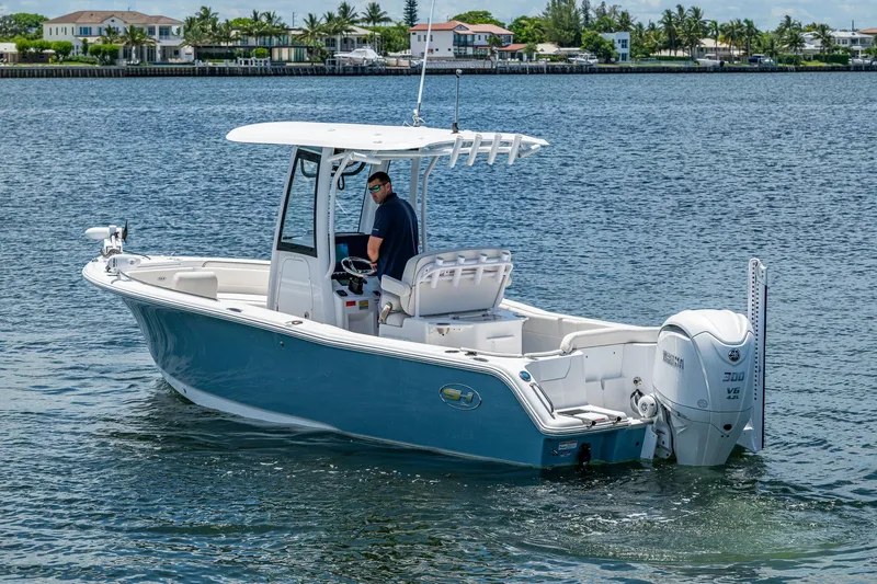 Slide: The Image of 2024 Sea Hunt Ultra 239 SE boat cruising on a calm waterway. - 33