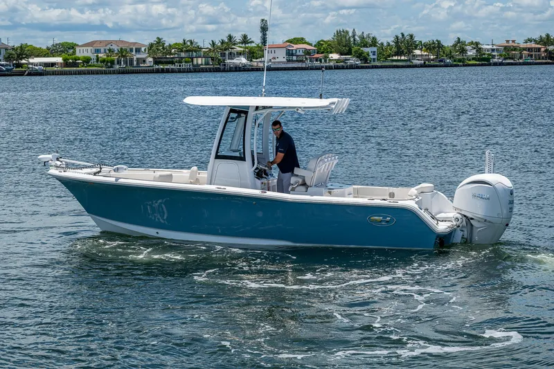 Slide: The Image of 2024 Sea Hunt Ultra 239 SE boat cruising on a calm waterway. - 34