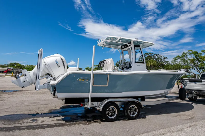 Slide: The Image of 2024 Sea Hunt Ultra 239 SE boat on trailer under clear blue sky. - 37