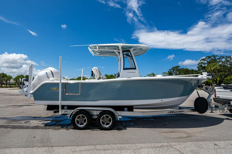 Slide: The Image of 2024 Sea Hunt Ultra 239 SE boat on trailer under clear blue sky. - 38
