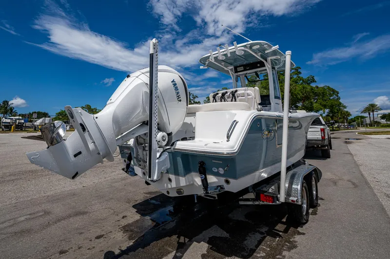 Slide: The Image of 2024 Sea Hunt Ultra 239 SE boat with Yamaha engine on trailer, under clear blue sky. - 39