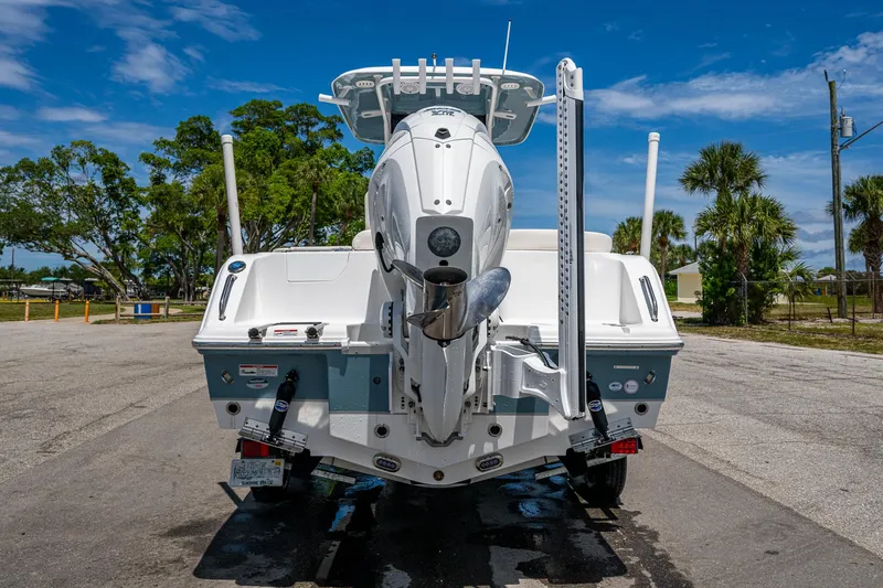 Slide: The Image of 2024 Sea Hunt Ultra 239 SE boat rear view, parked on a sunny day. - 40